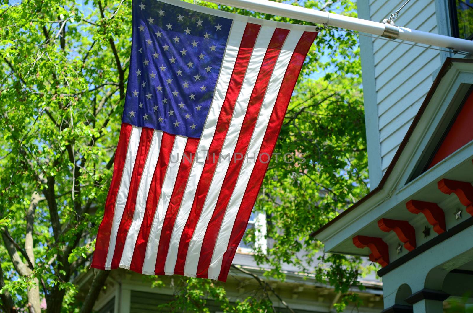 American Flag Outside A House In Small Town USA