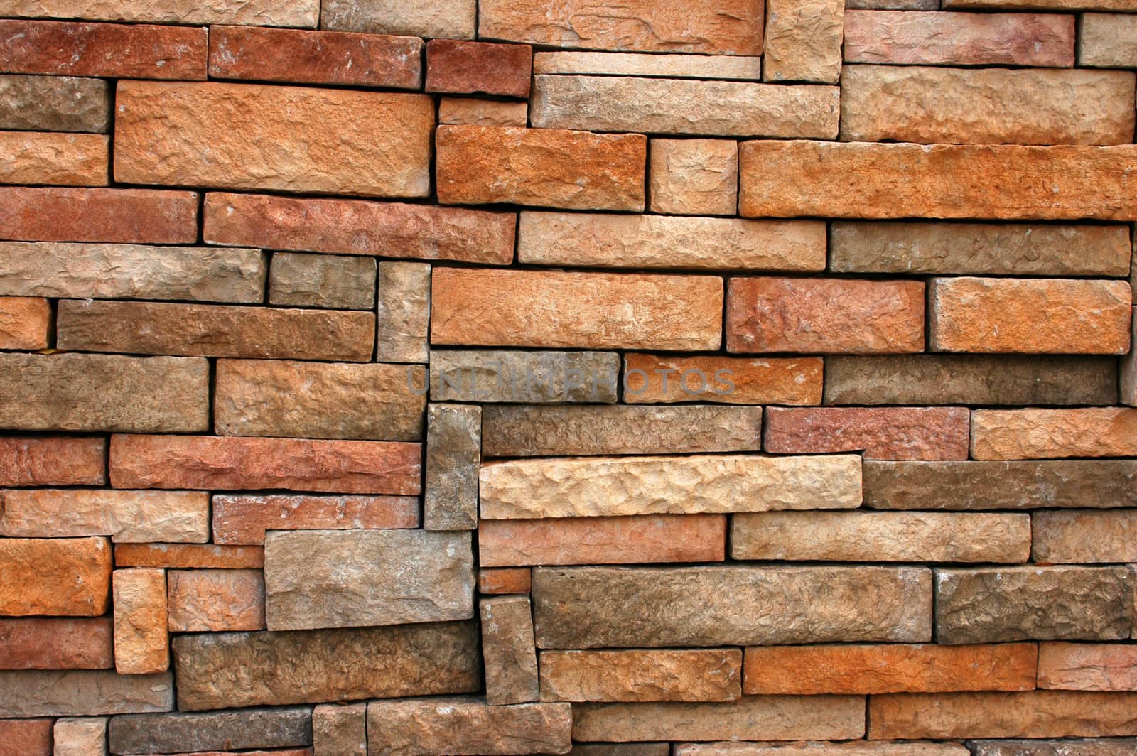 Background Texture Of A Wall With Uneven Bricks