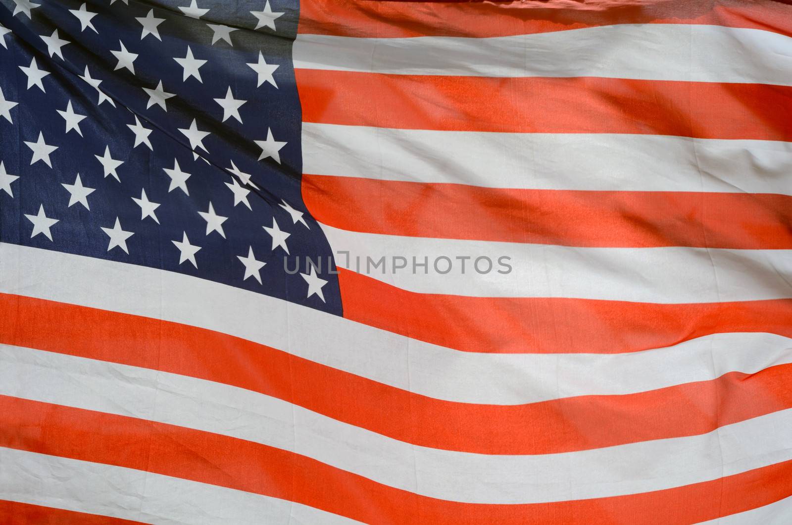Background Texture Of USA Stars And Stripes Flag In The Wind