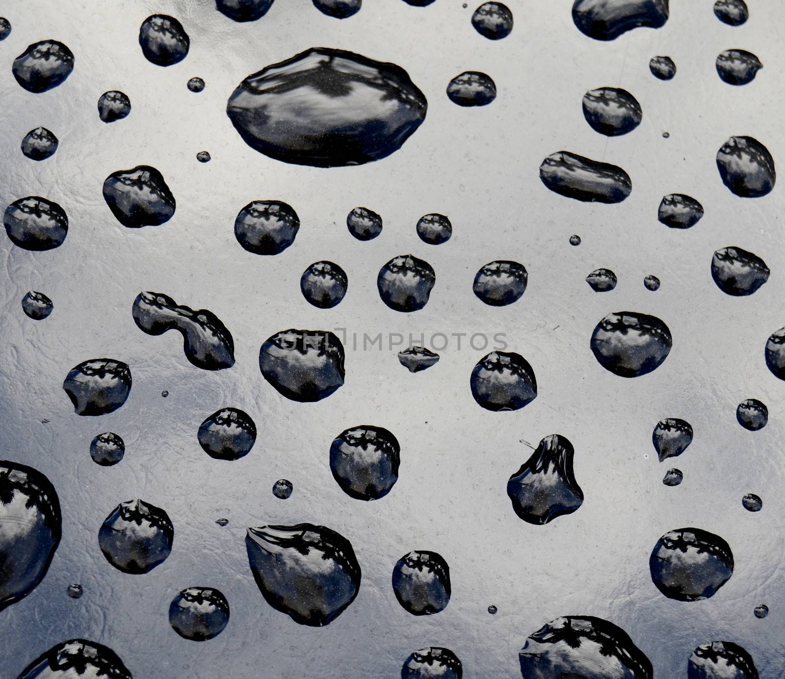 Background Of Pristine Water Drops On Black Metal Surface