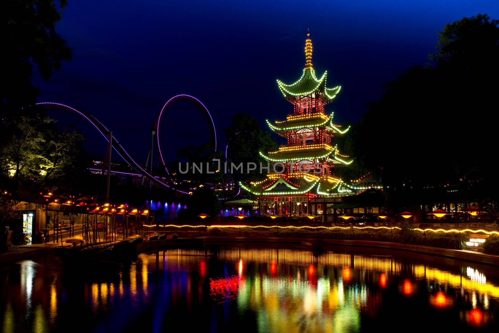 Oriental Pagoda  in Tivoli, Copenhagen, illuminated and reflecting in a pond
