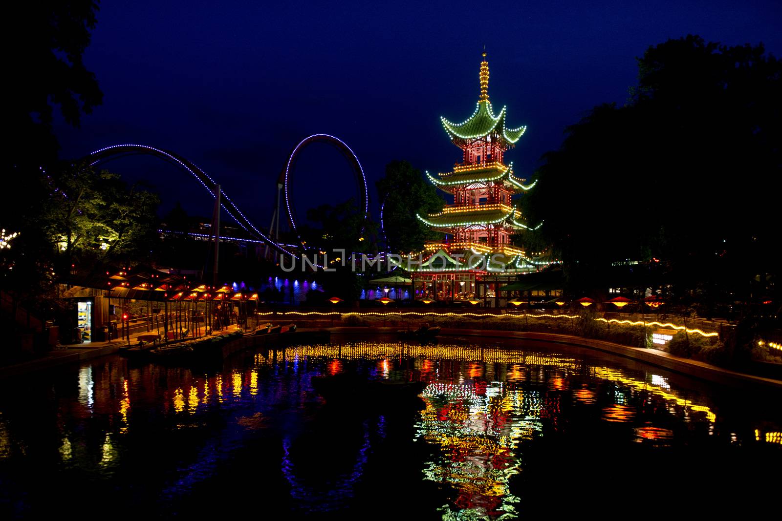 Oriental Pagoda  in Tivoli, Copenhagen, illuminated and reflecting in a pond