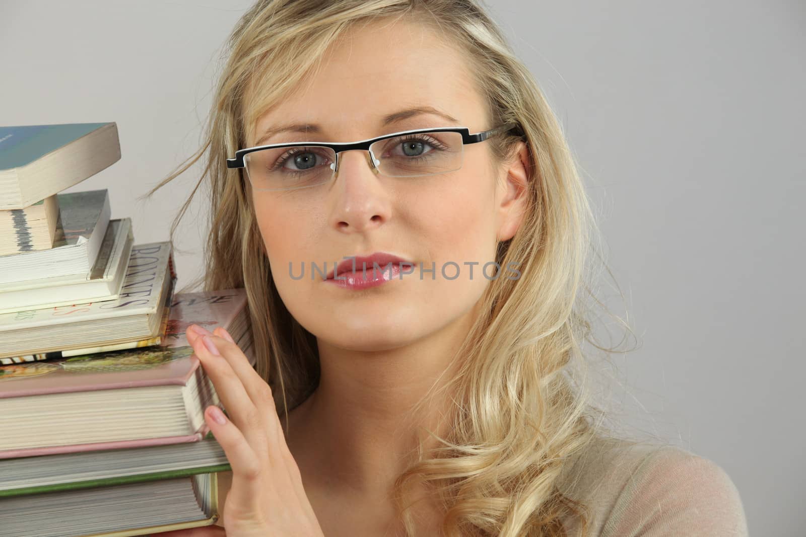 Blond woman with stack of books