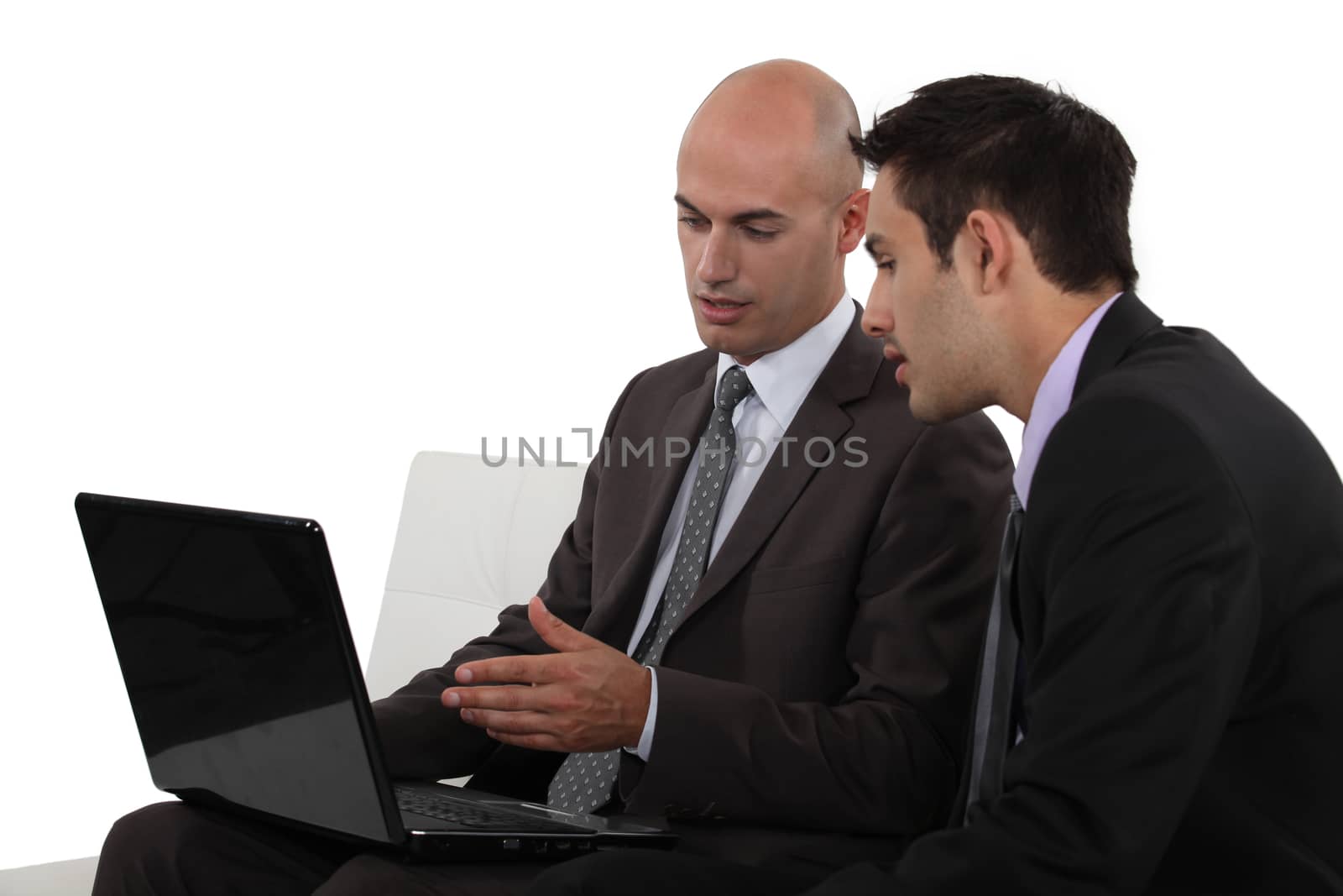 Two businessmen using laptop