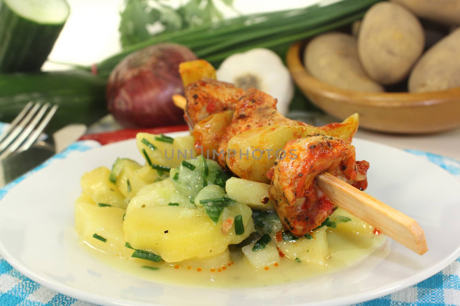 a Potato-cucumber salad with a fiery skewer