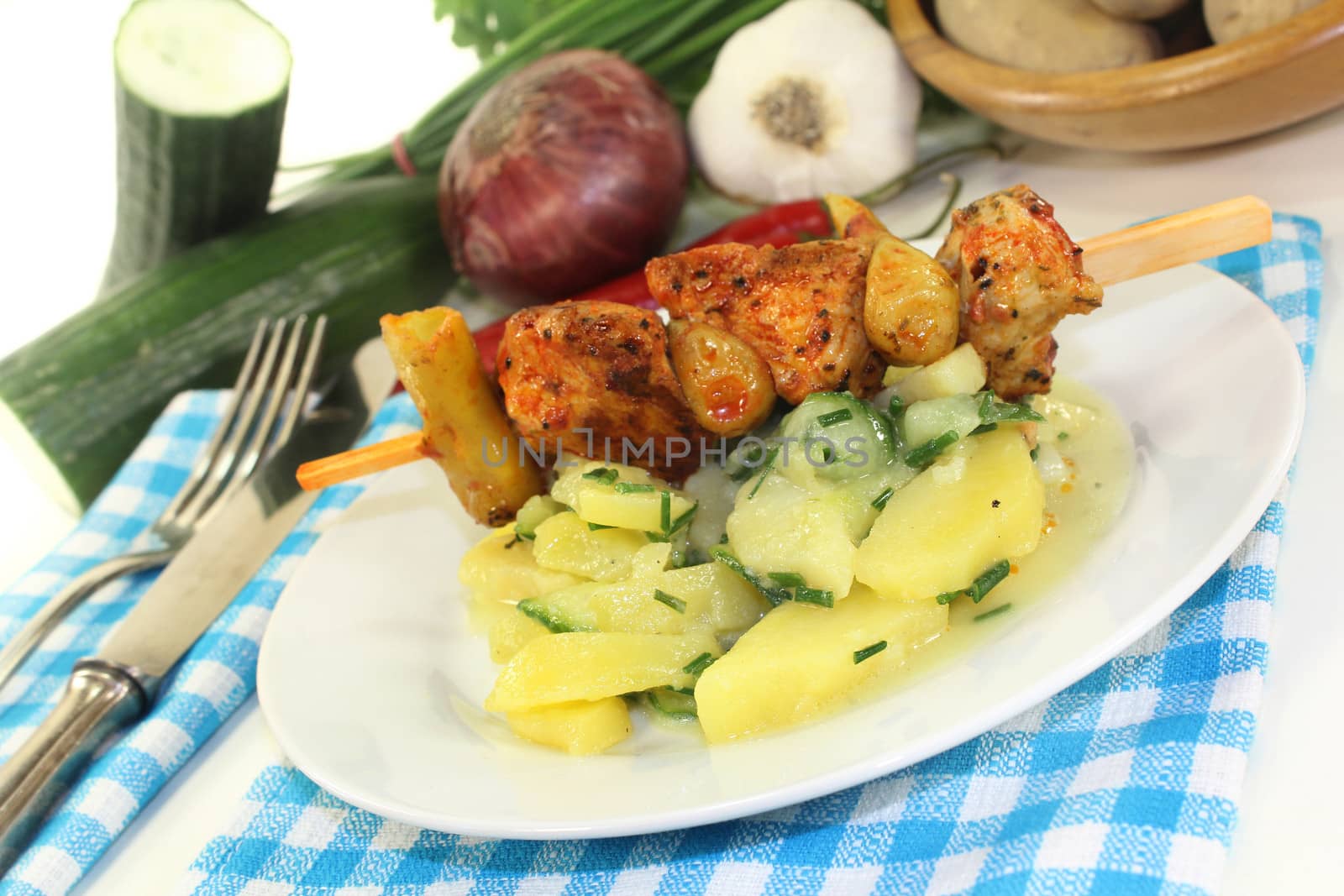 a Potato-cucumber salad with a fiery skewer