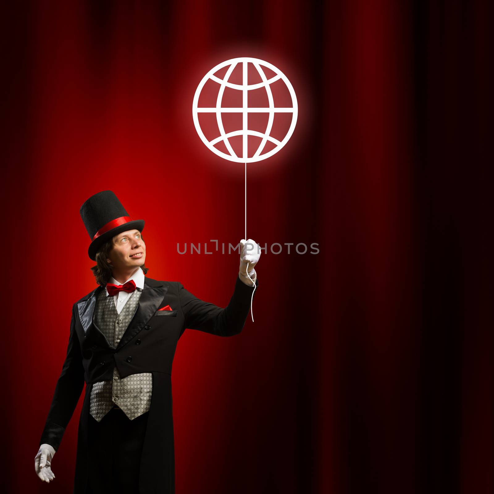 Image of man magician with balloon against color background