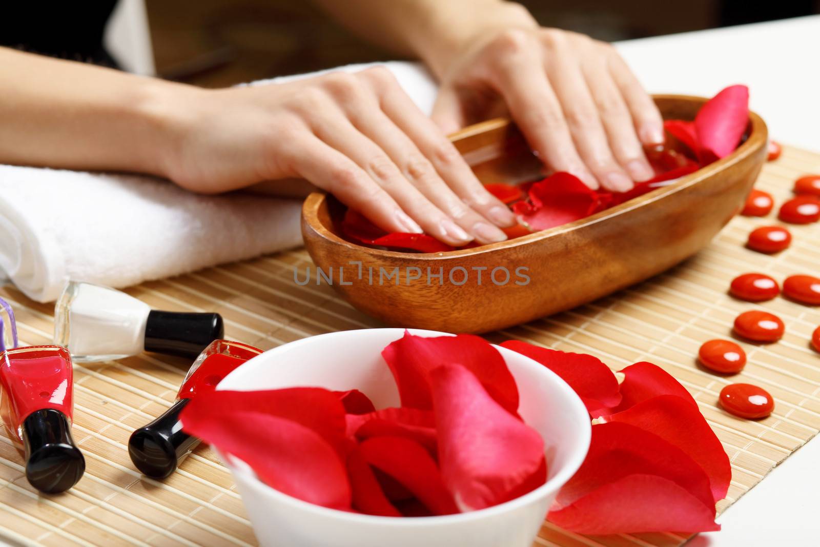 Young woman is getting manicure in a beauty salon