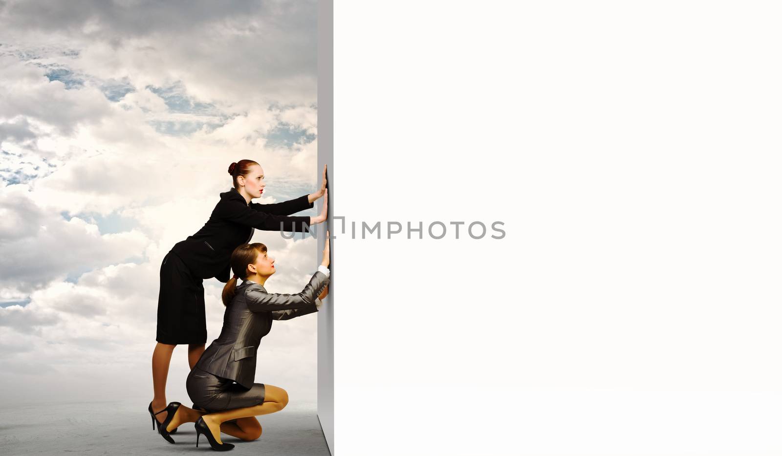 Two businesswoman pushing blank white banner. Place for text