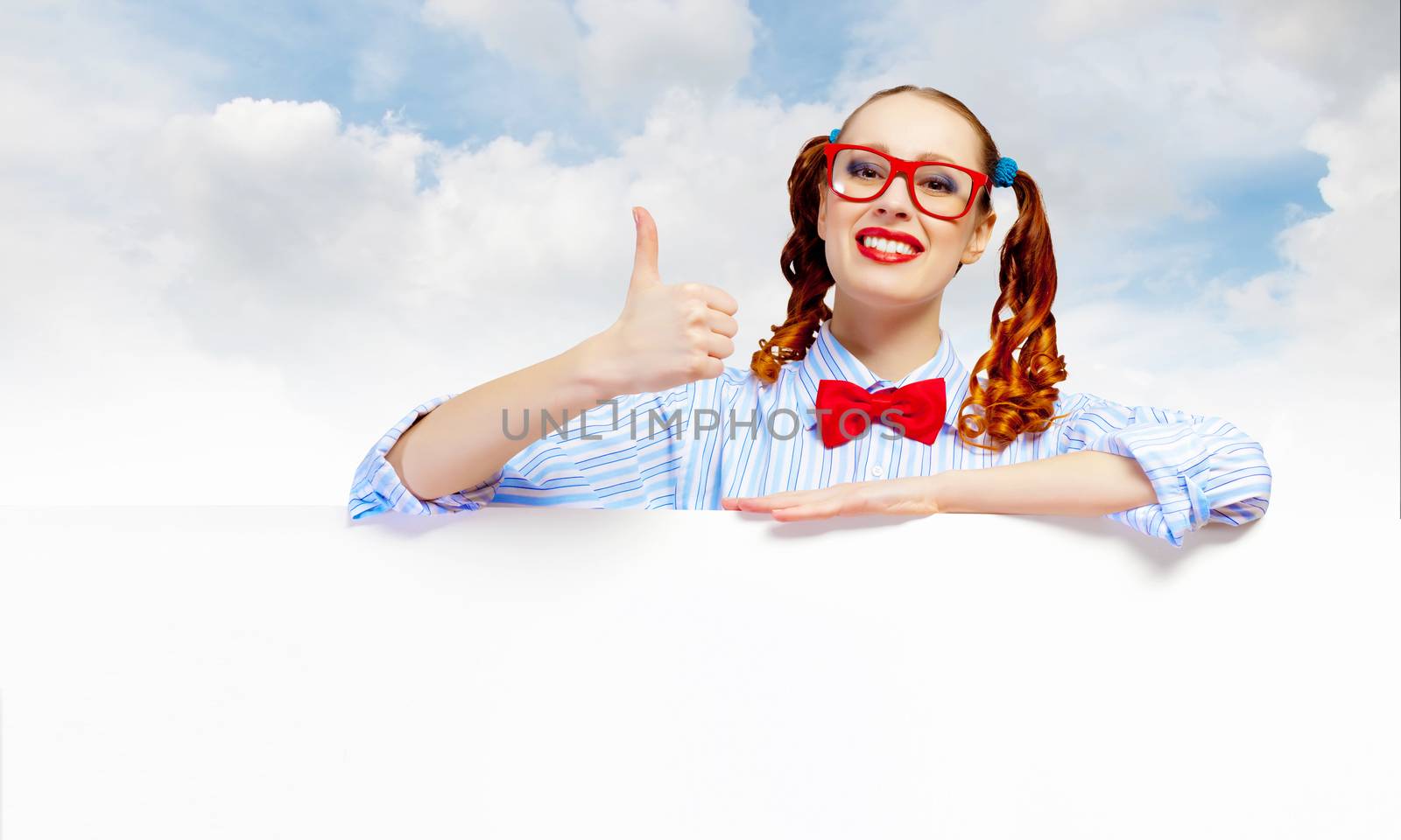 Young woman holding a blank white billboard