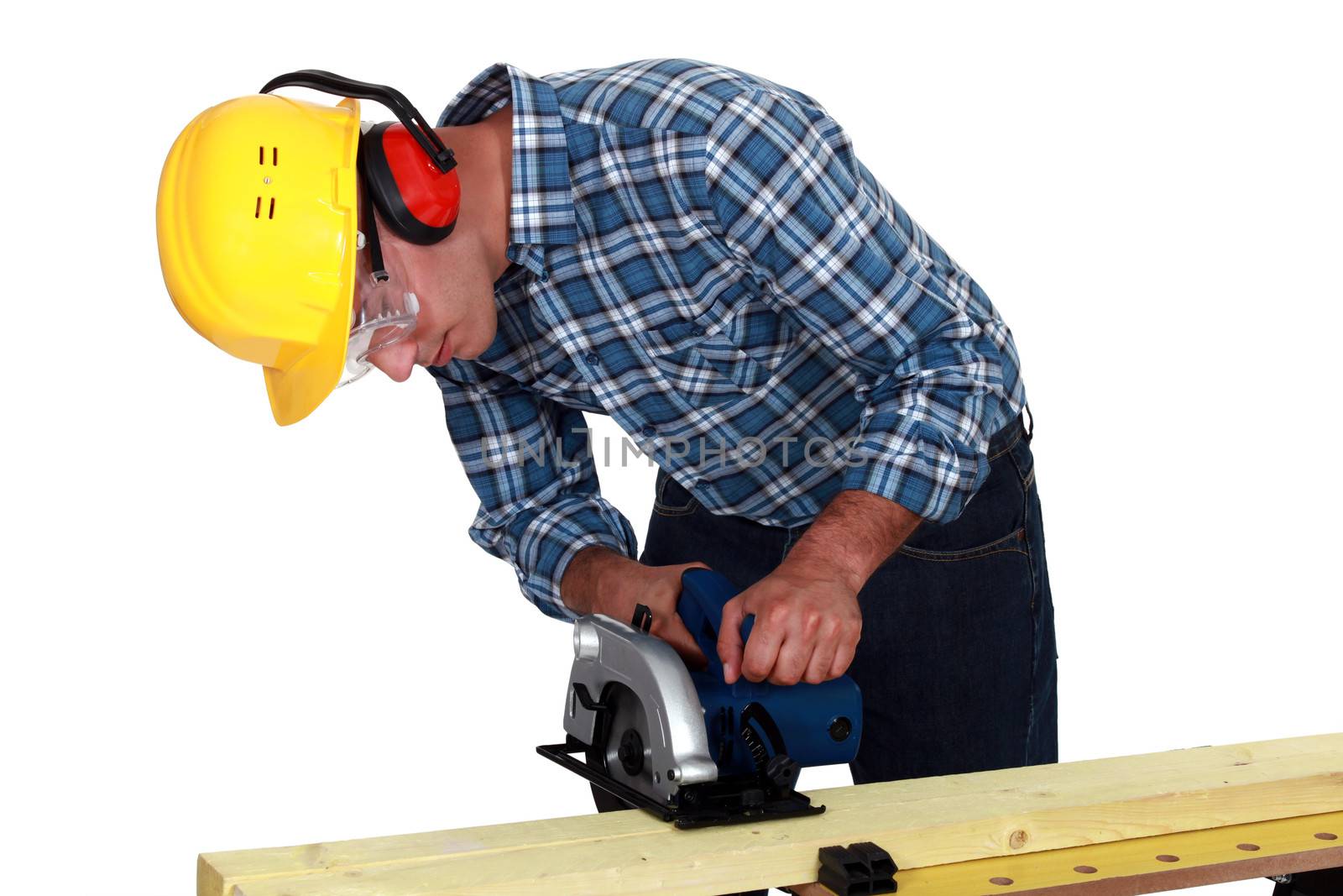 Carpenter using band saw by phovoir