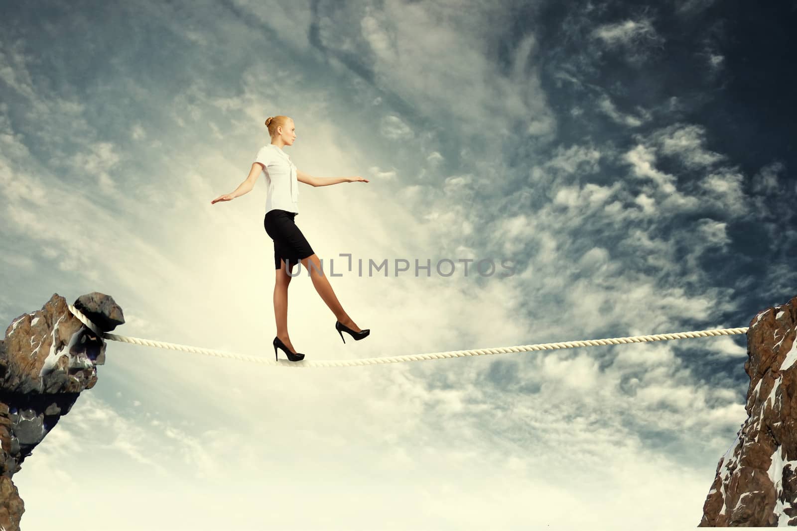 Businesswoman balancing on rope by sergey_nivens