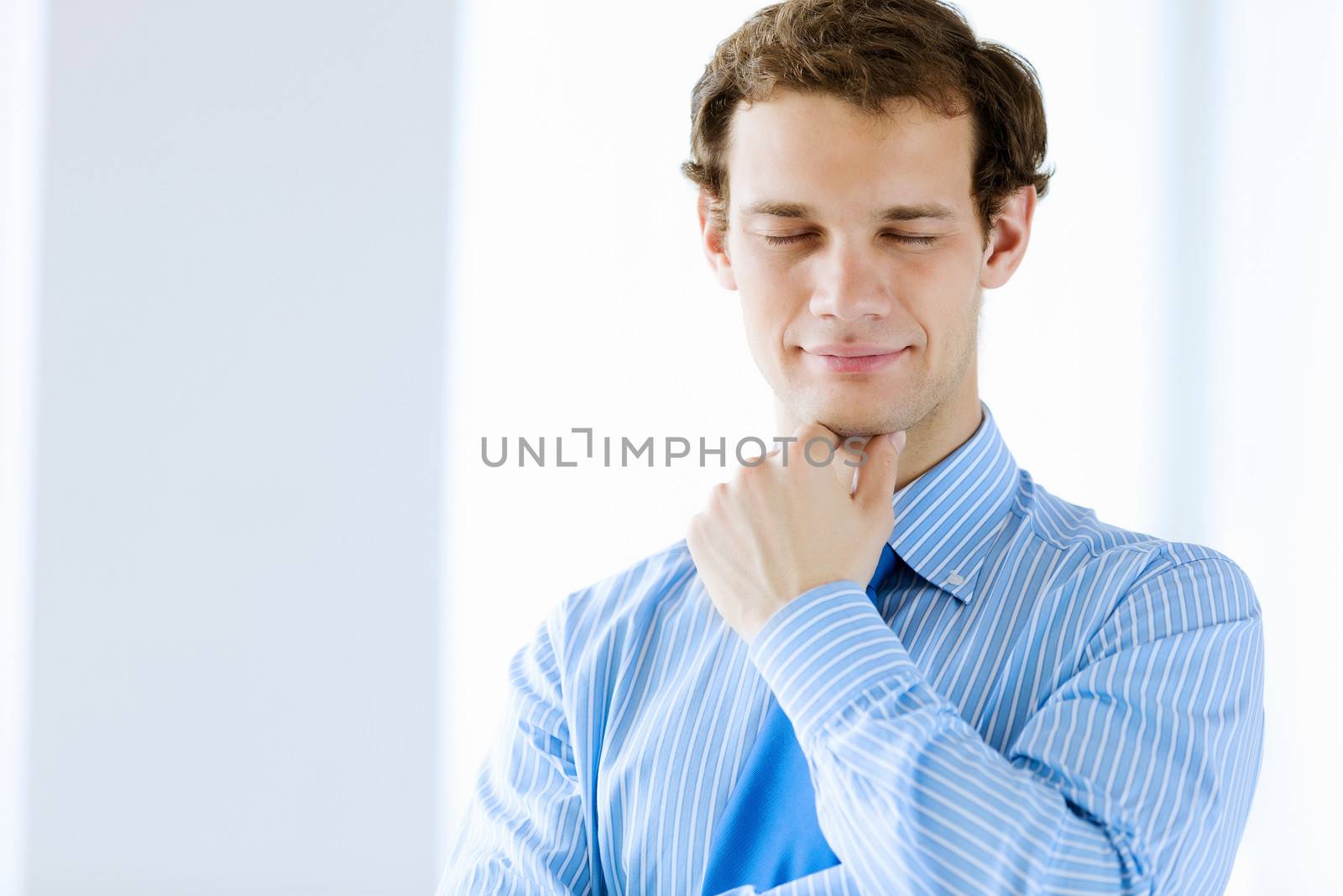 Image of young handsome confident businessman in suit