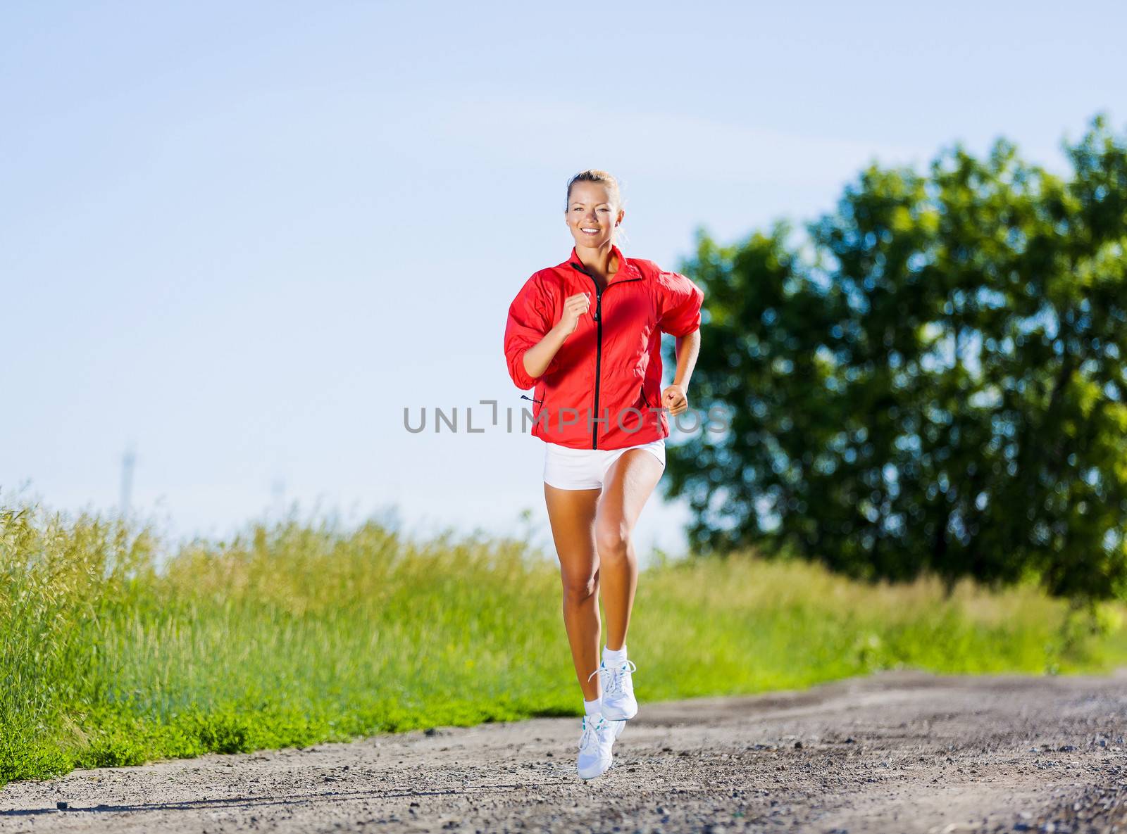 Image of young attractive woman running outdoor