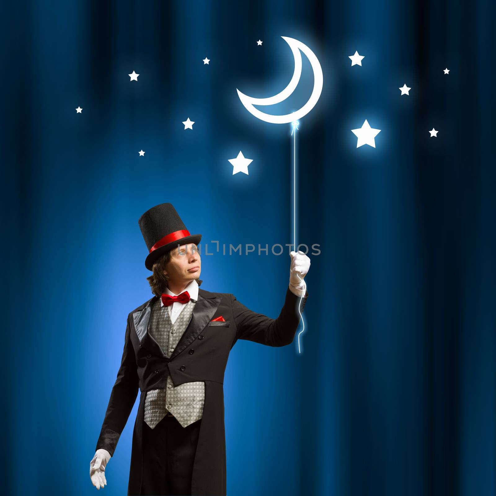 Image of man magician with balloon against color background