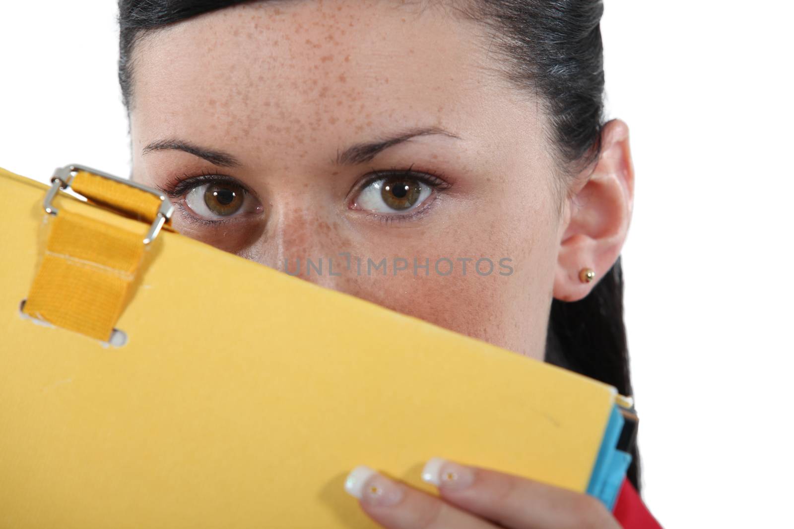 Shy woman hiding behind folder