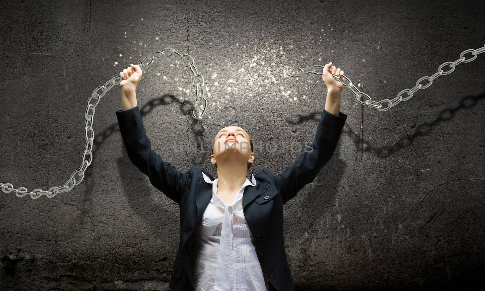 Image of businesswoman in anger breaking metal chain