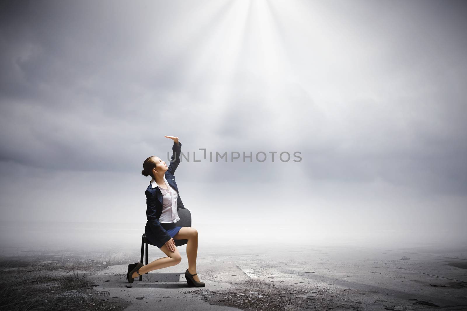 Image of businesswoman sitting on chair under sun lights