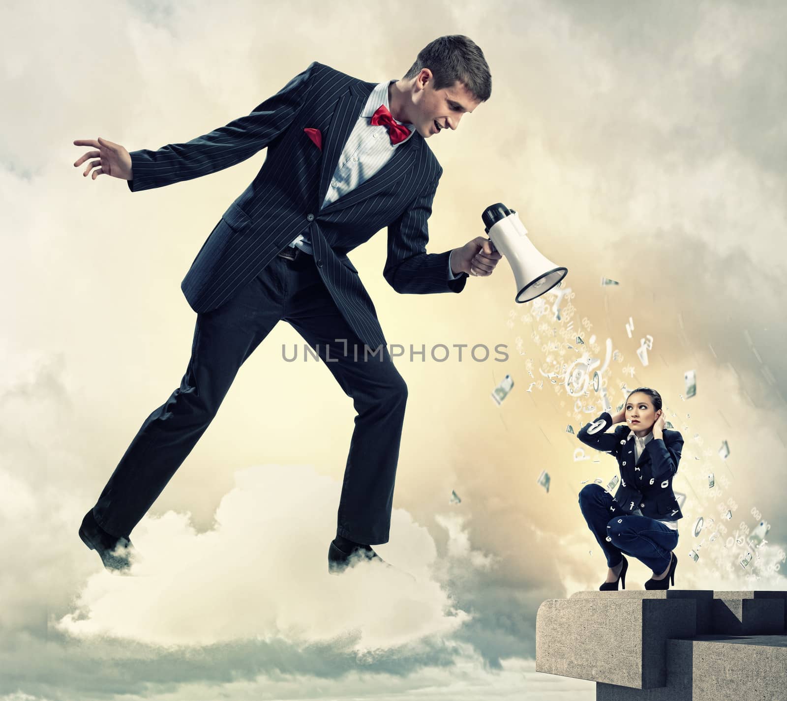 Angry businessman with megaphone shouting at colleague