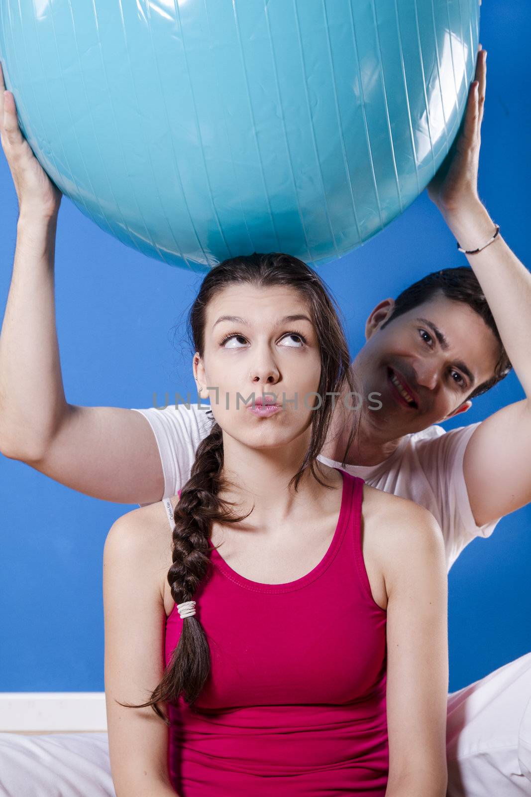 Happy athletic couple with fitness ball. by FernandoCortes