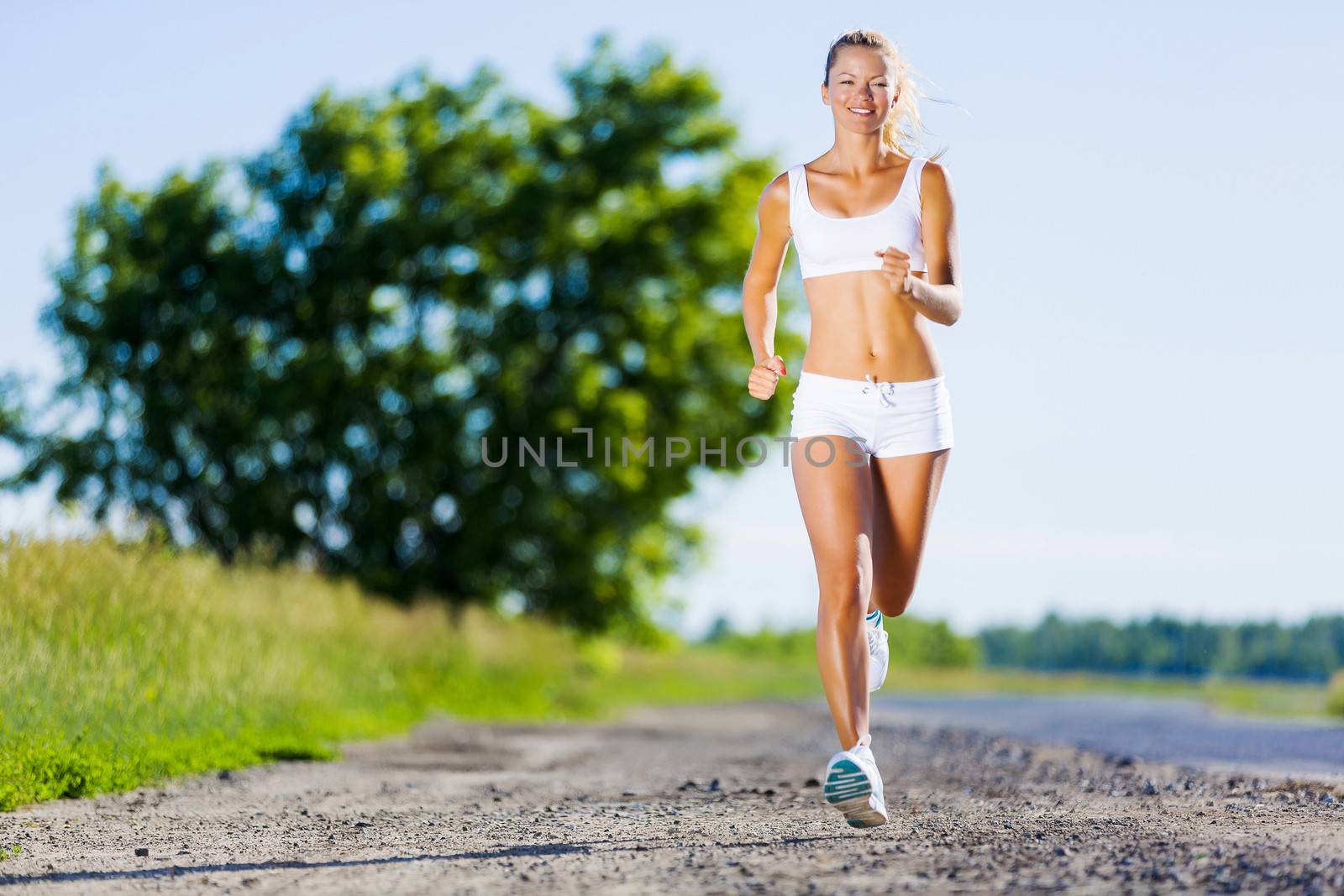 Image of young attractive woman running outdoor