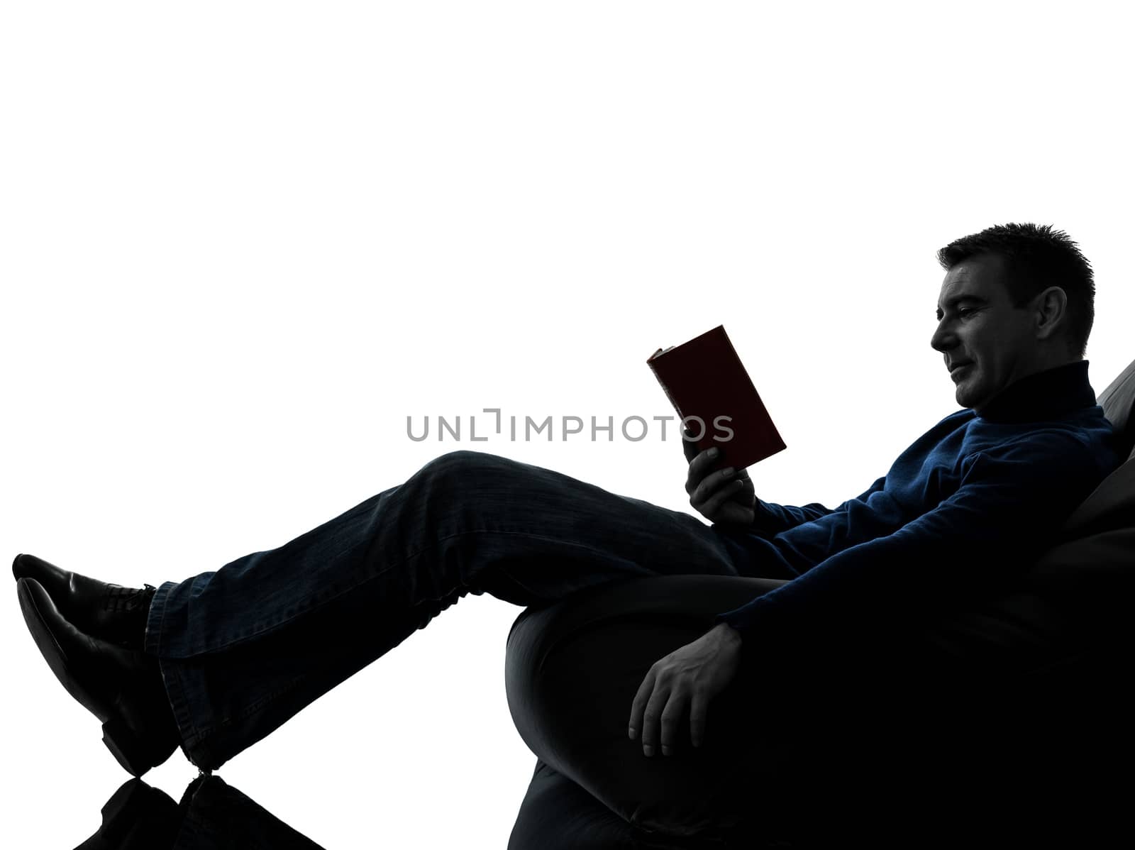 man reading book silhouette full length by PIXSTILL