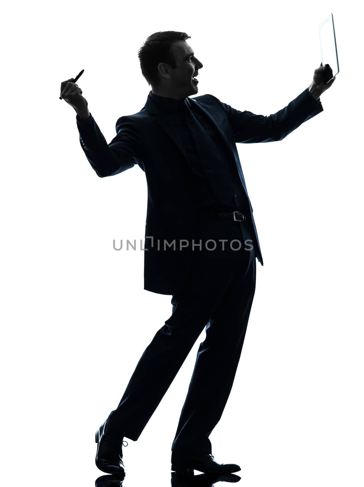 one caucasian business man holding digital pen stylus tablet    in silhouette on white background