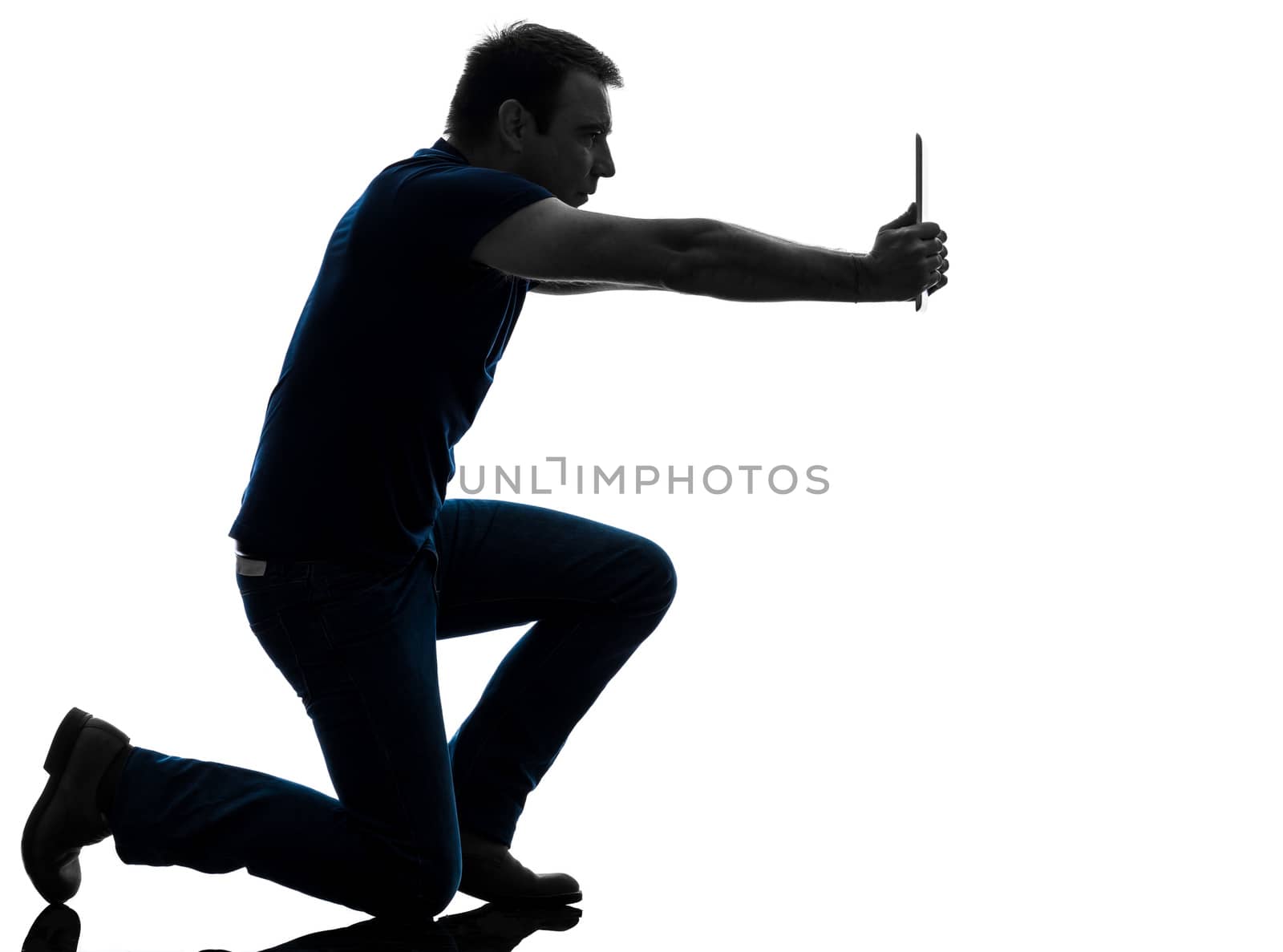 one caucasian man photographing with digital tablet   in silhouette on white background