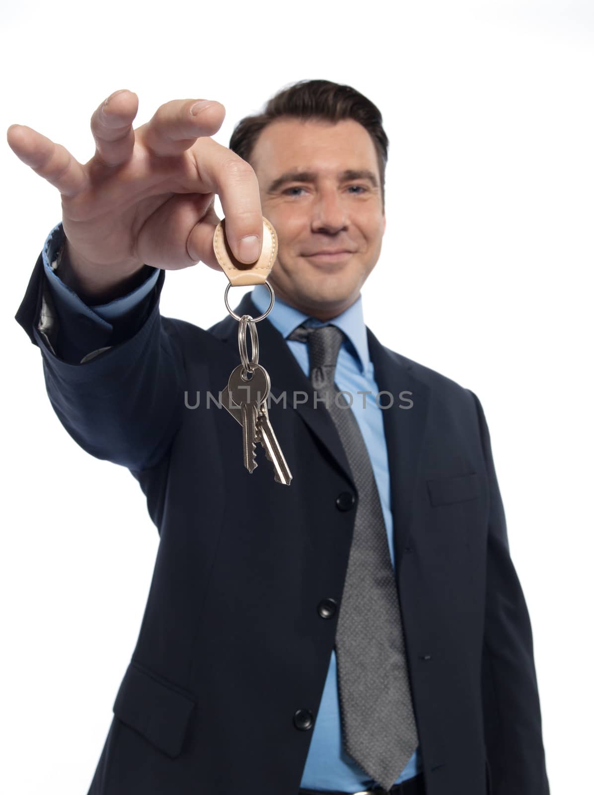 one caucasian realtor man real estate agent businessman teasing holding offering keys isolated studio on white background