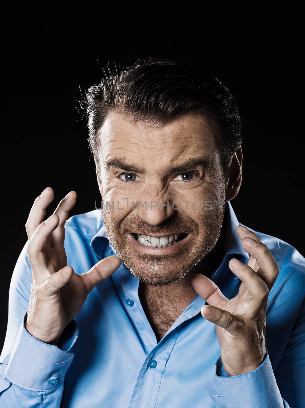 caucasian man unshaven anger portrait isolated studio on black background