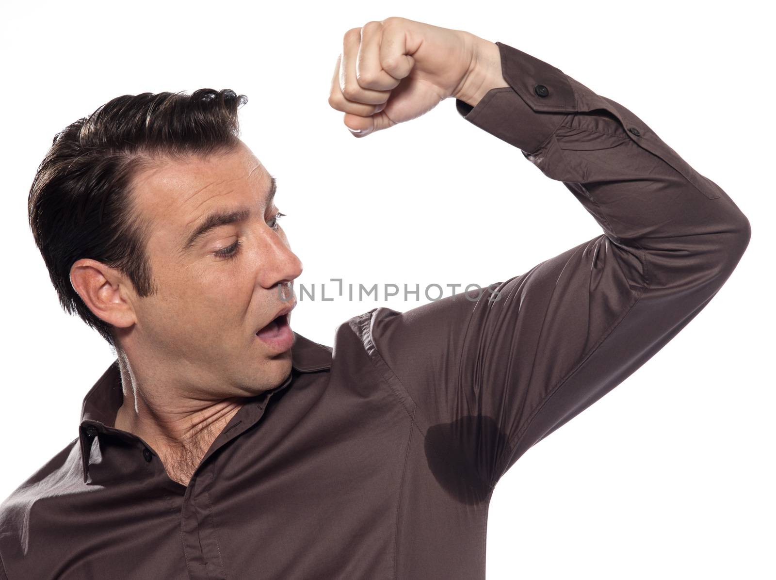 one caucasian man looking at sweat stain  sweating perspiring stain surprised isolated studio on white background