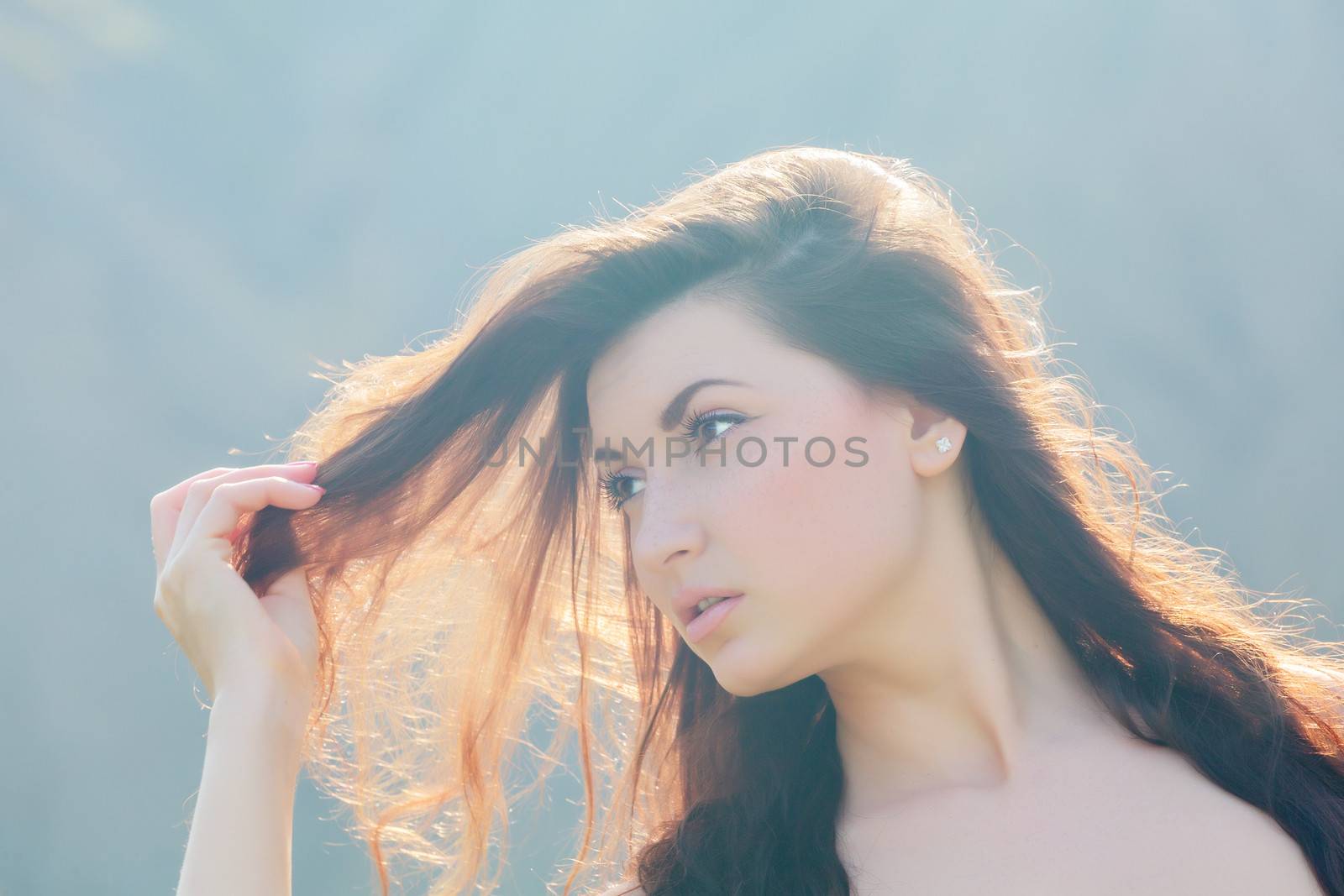 Portrait of a beautiful girl playing with her hair. soft focus