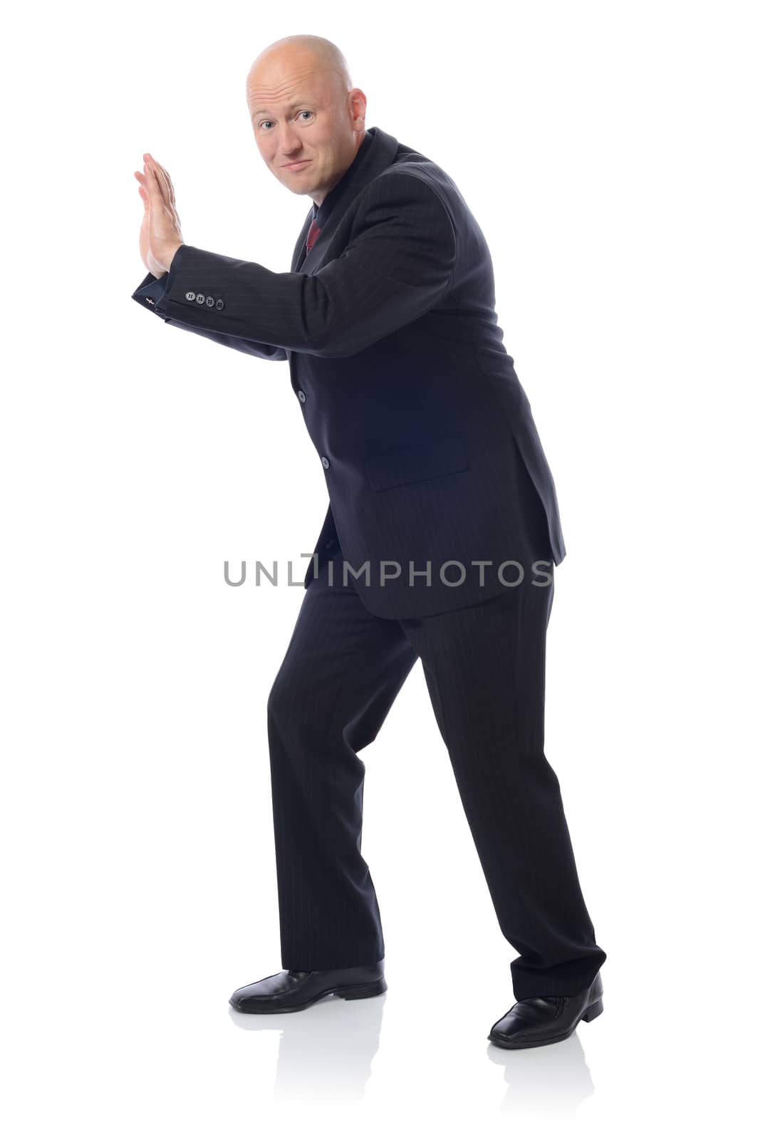 Businessman in full growth rests on the invisible wall. Isolated on white background 