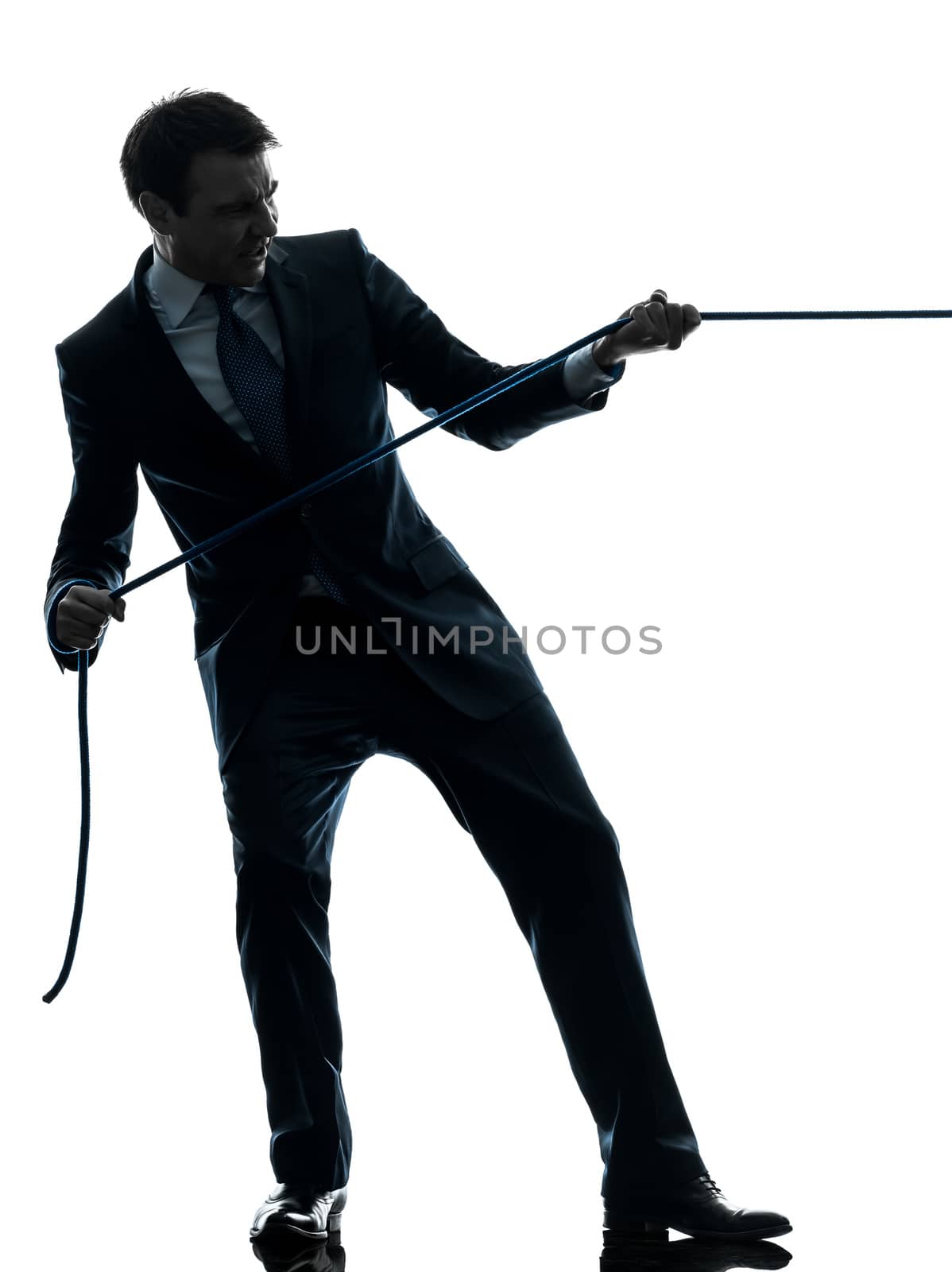 one caucasian business man pulling a rope in silhouette studio isolated on white background