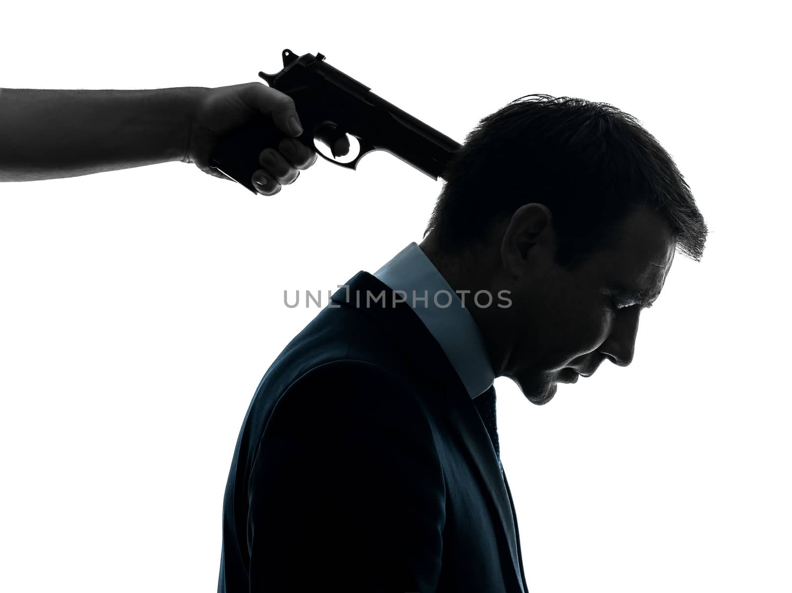 one caucasian businessman with gun pointing to his head in silhouette studio isolated on white background