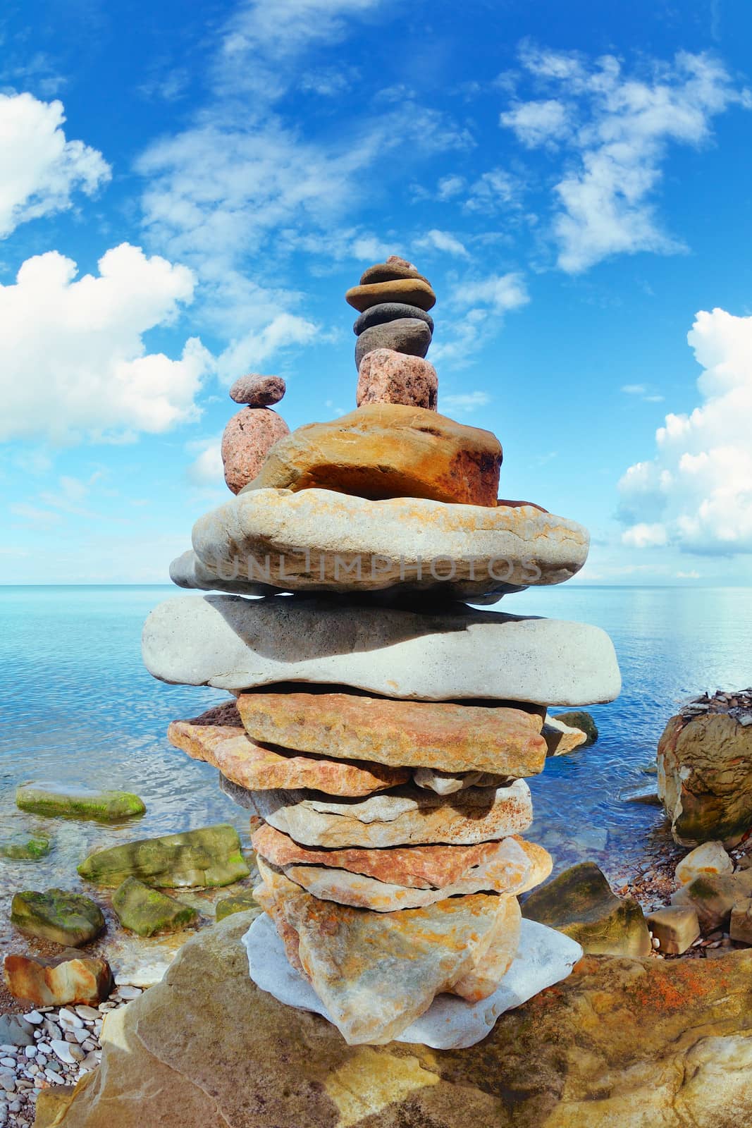 Pile of pebbles on the sea boulder