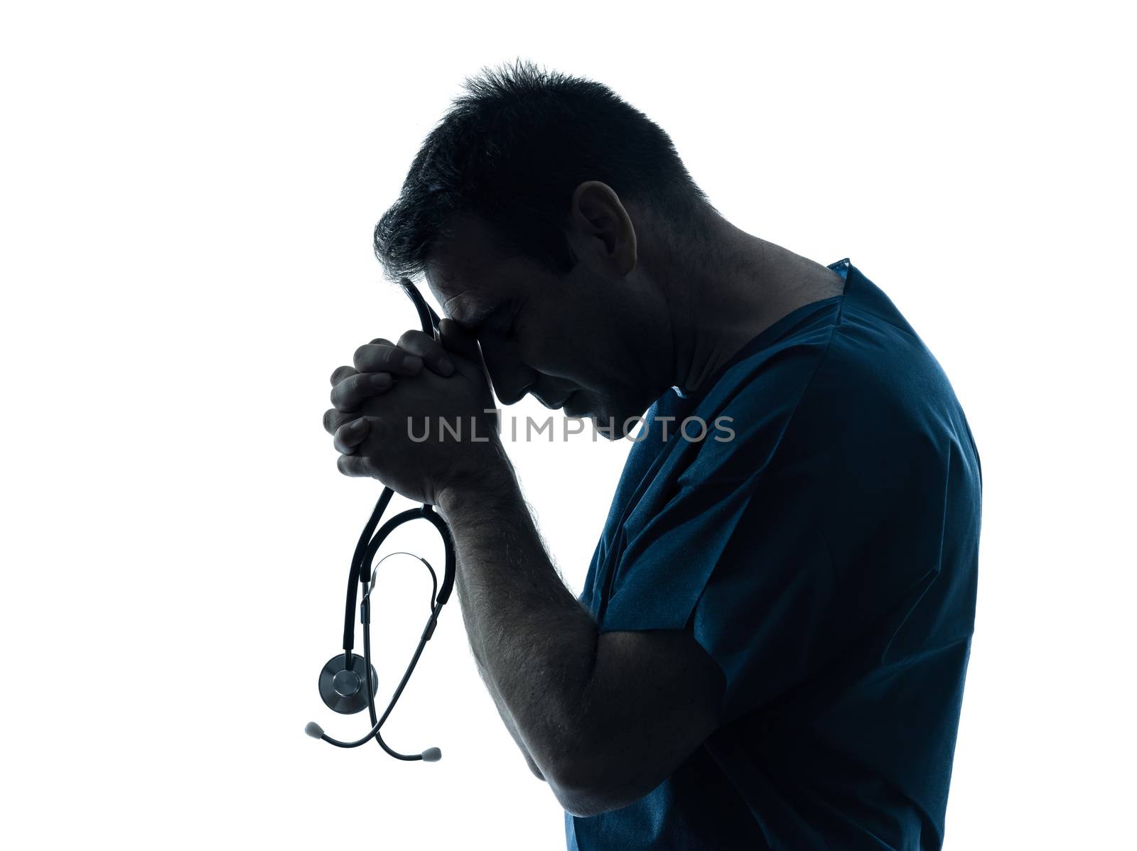 one caucasian man doctor surgeon medical worker praying silhouette isolated on white background