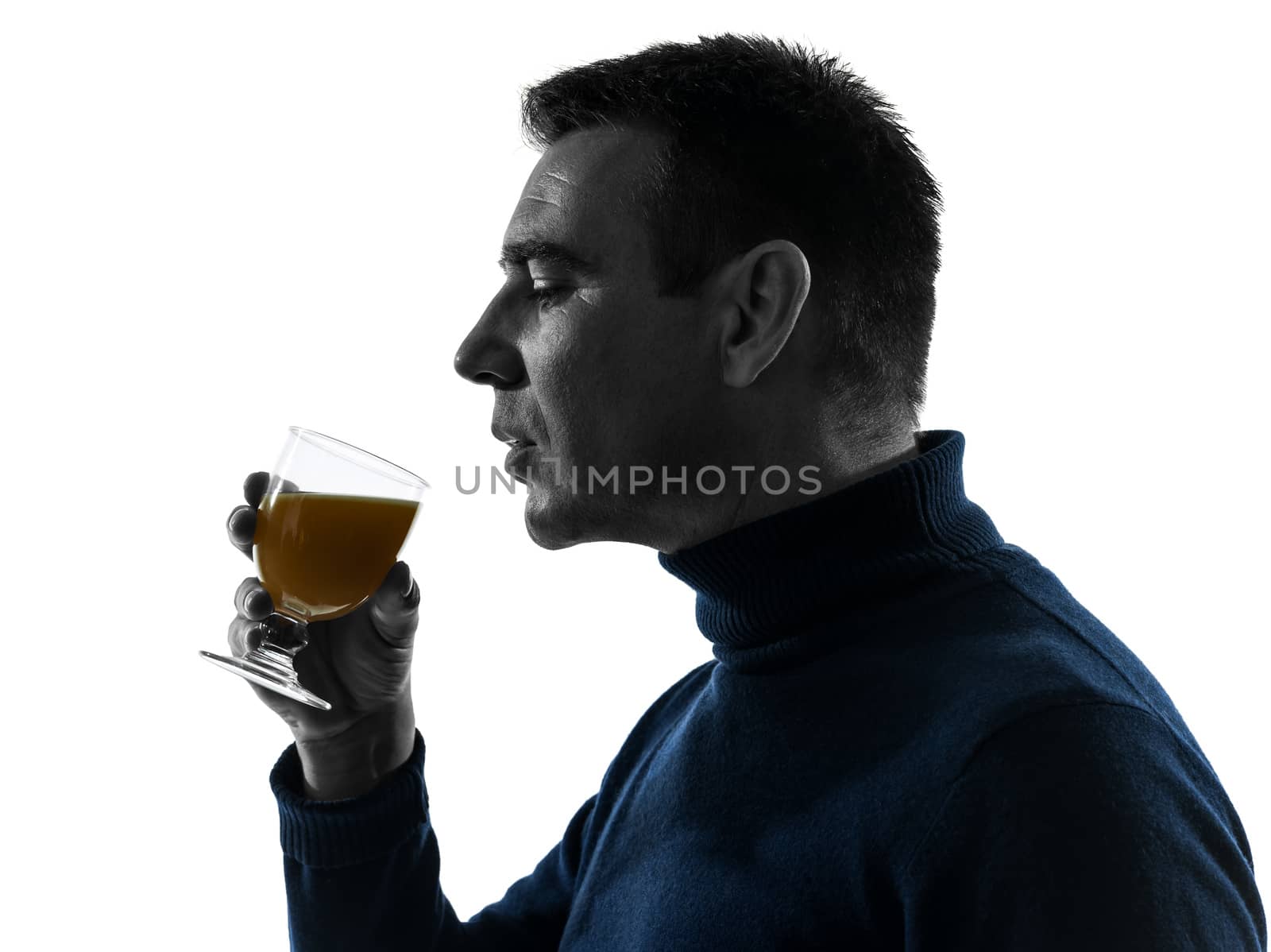 one caucasian man drinking orange juice  portrait in silhouette studio isolated on white background