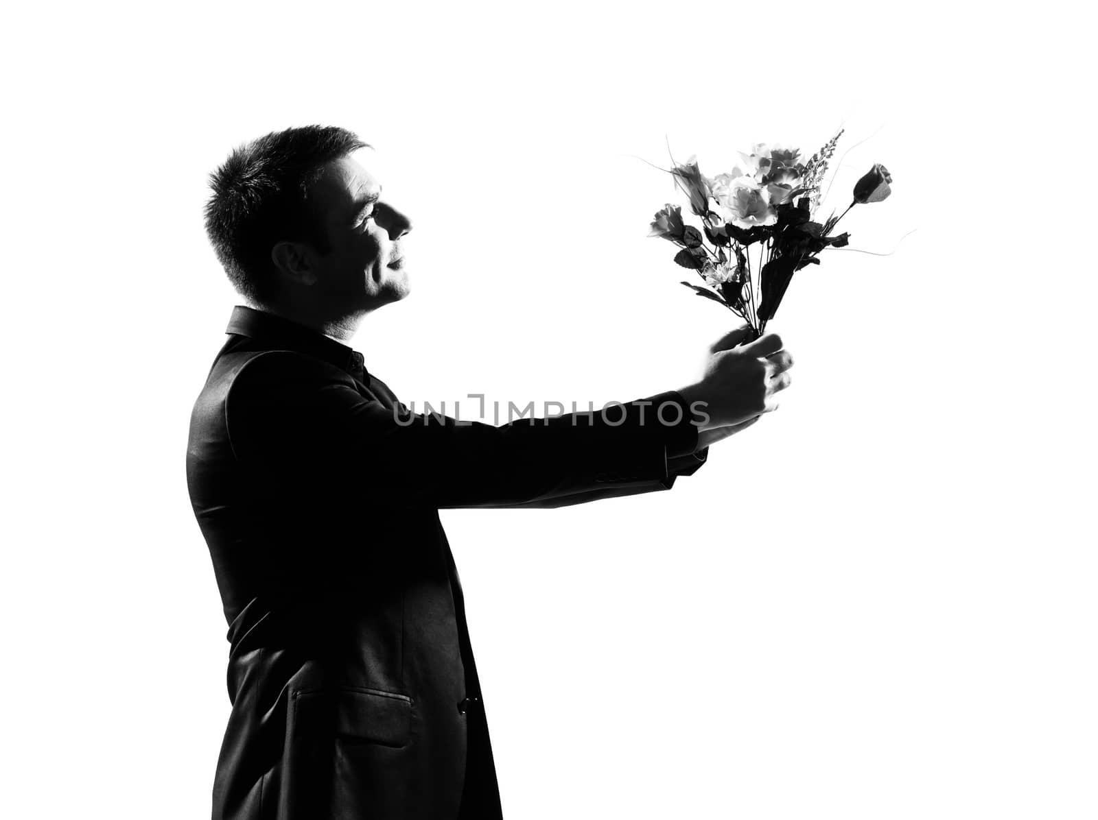 silhouette portrait one caucasian business man holding offering  flowers bouquet  on studio isolated white background