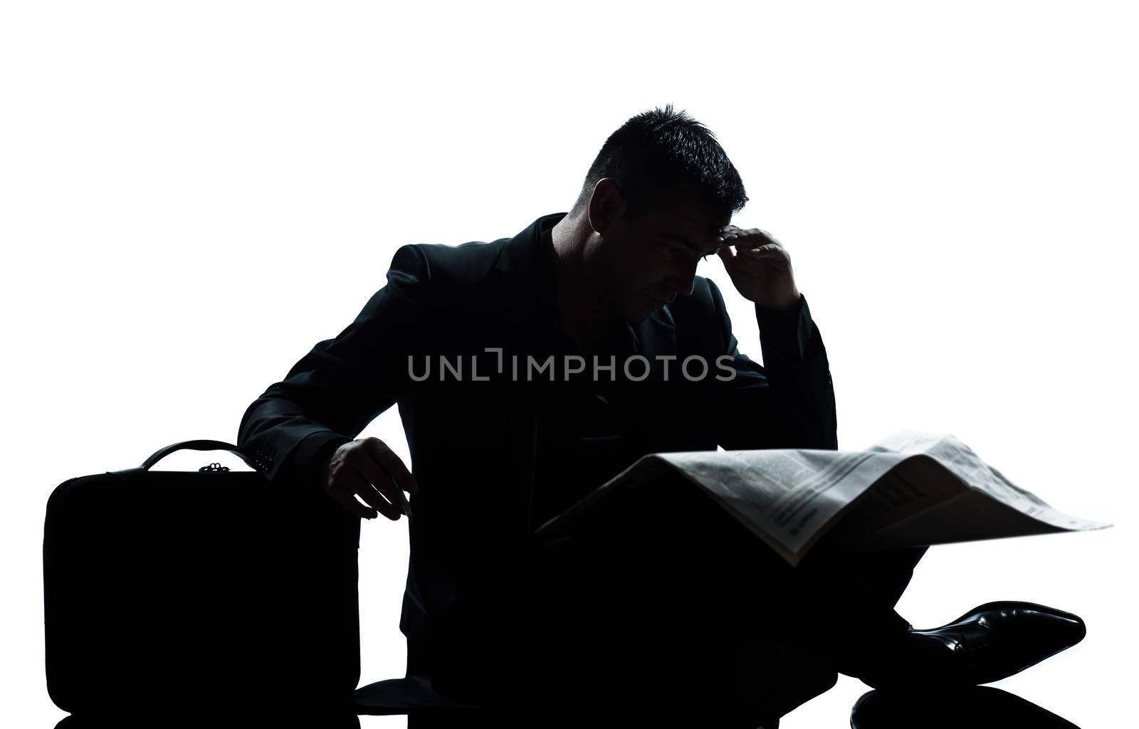 silhouette man despair full length sitting reading newspaper  by PIXSTILL