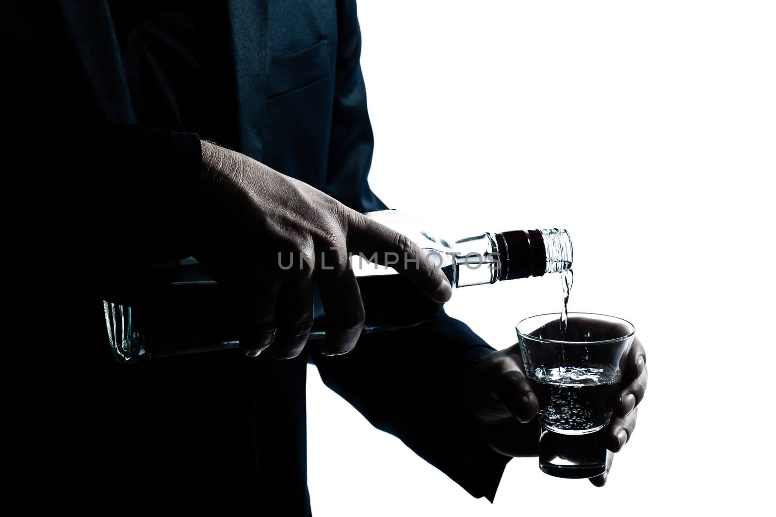 silhouette man hands close up pouring white alcohol by PIXSTILL