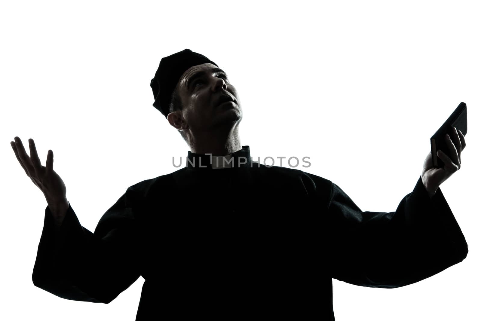 one caucasian man priest silhouette in studio isolated on white background