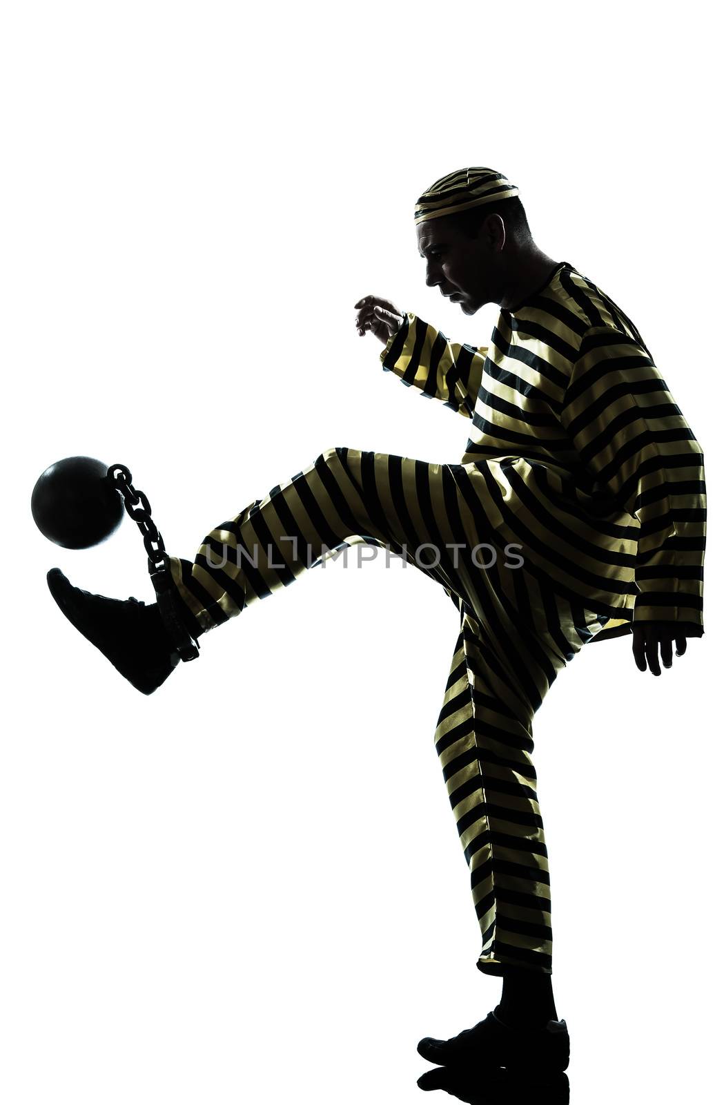 one caucasian man prisoner criminal playing soccer with chain ball in studio isolated on white background