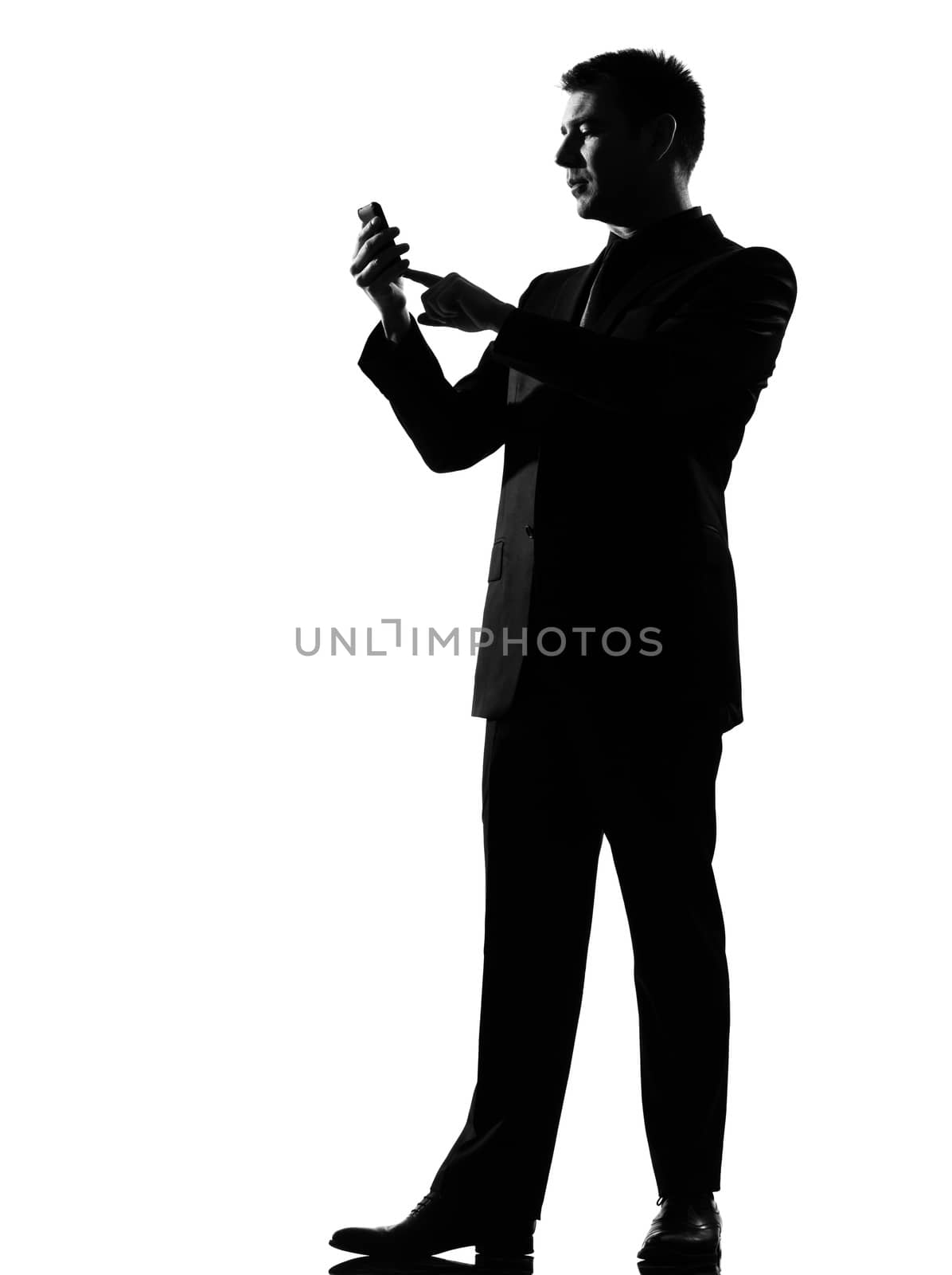 silhouette caucasian business man on the phone  sms text messaging full length on studio isolated white background