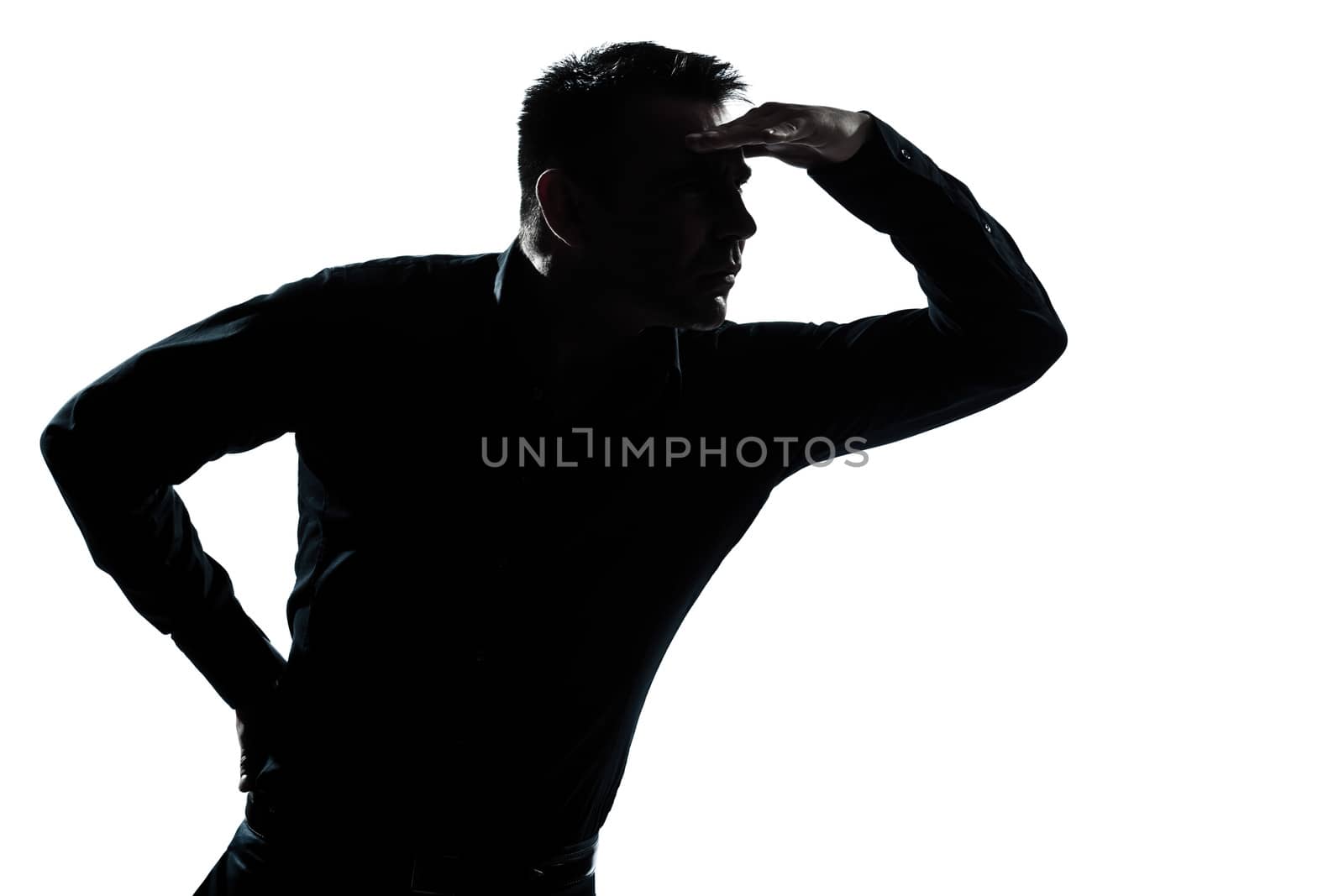one caucasian man portrait looking away forward gesture shielding eyes silhouette in studio isolated white background