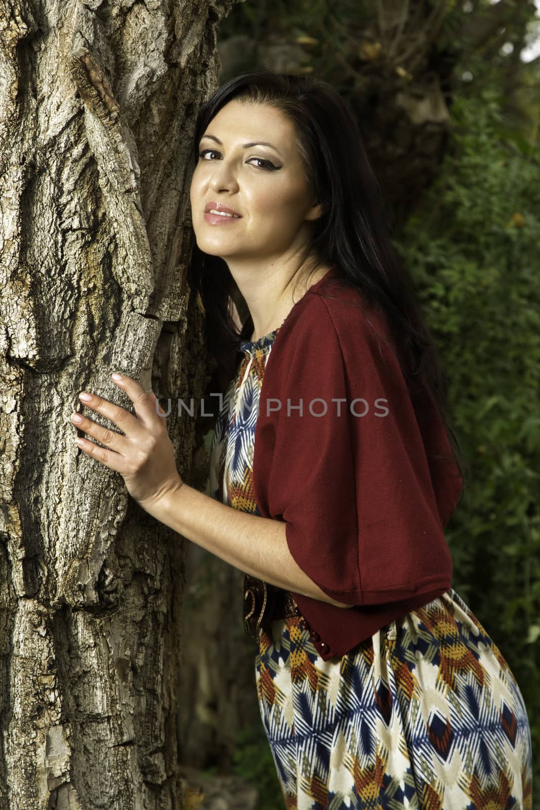 beautiful young woman relaxes on a park by membio