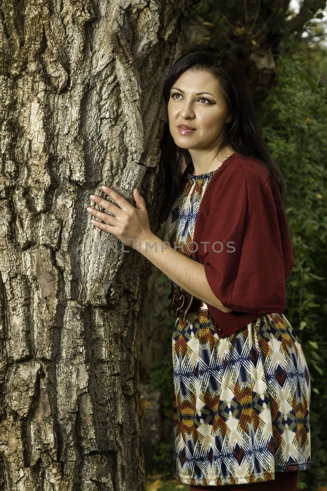 beautiful young woman relaxes on a park by membio