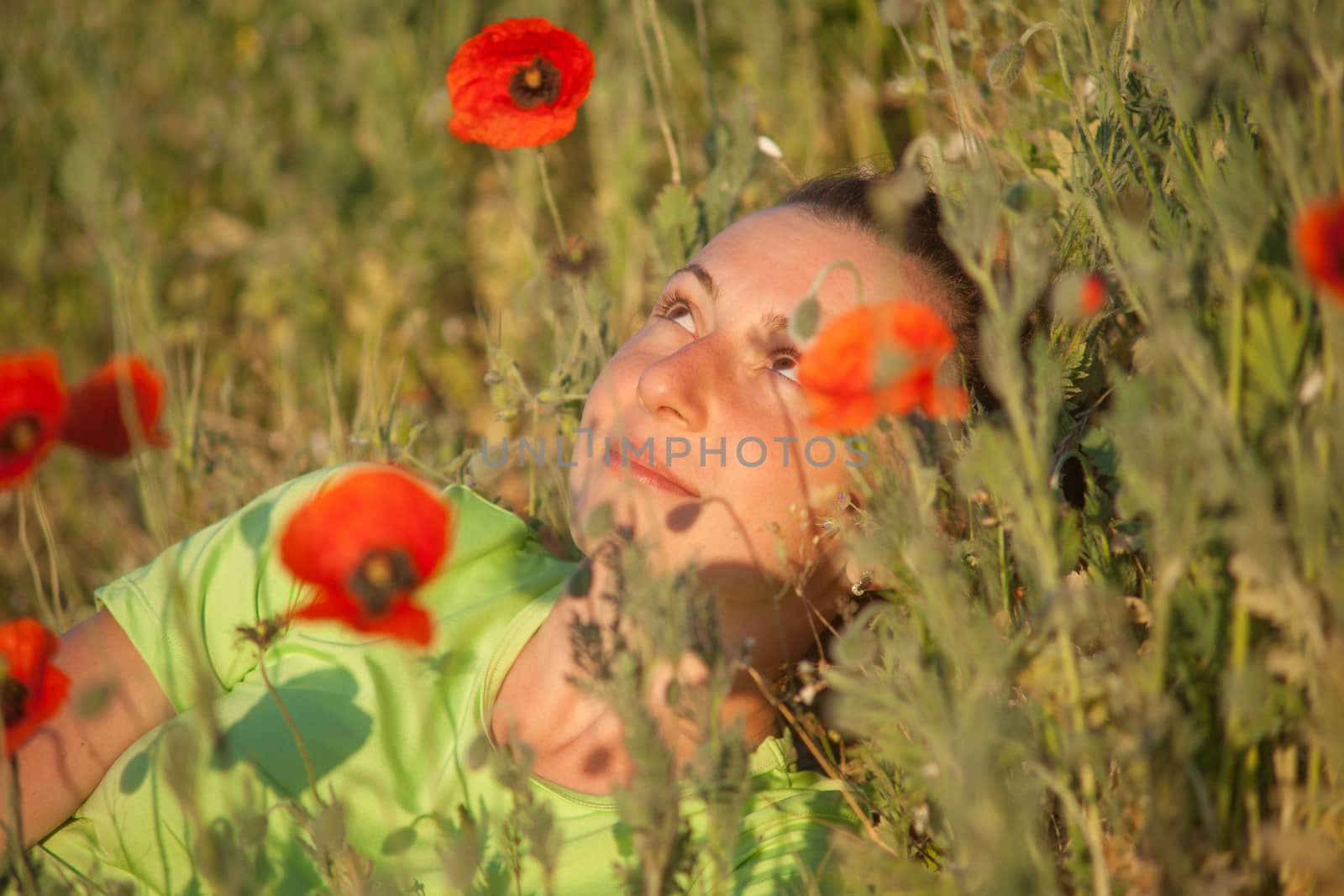 Young beautiful woman on cereal field in summer