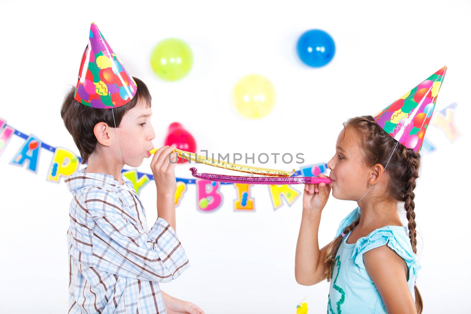 Cute girl and boy having fun at birthday party