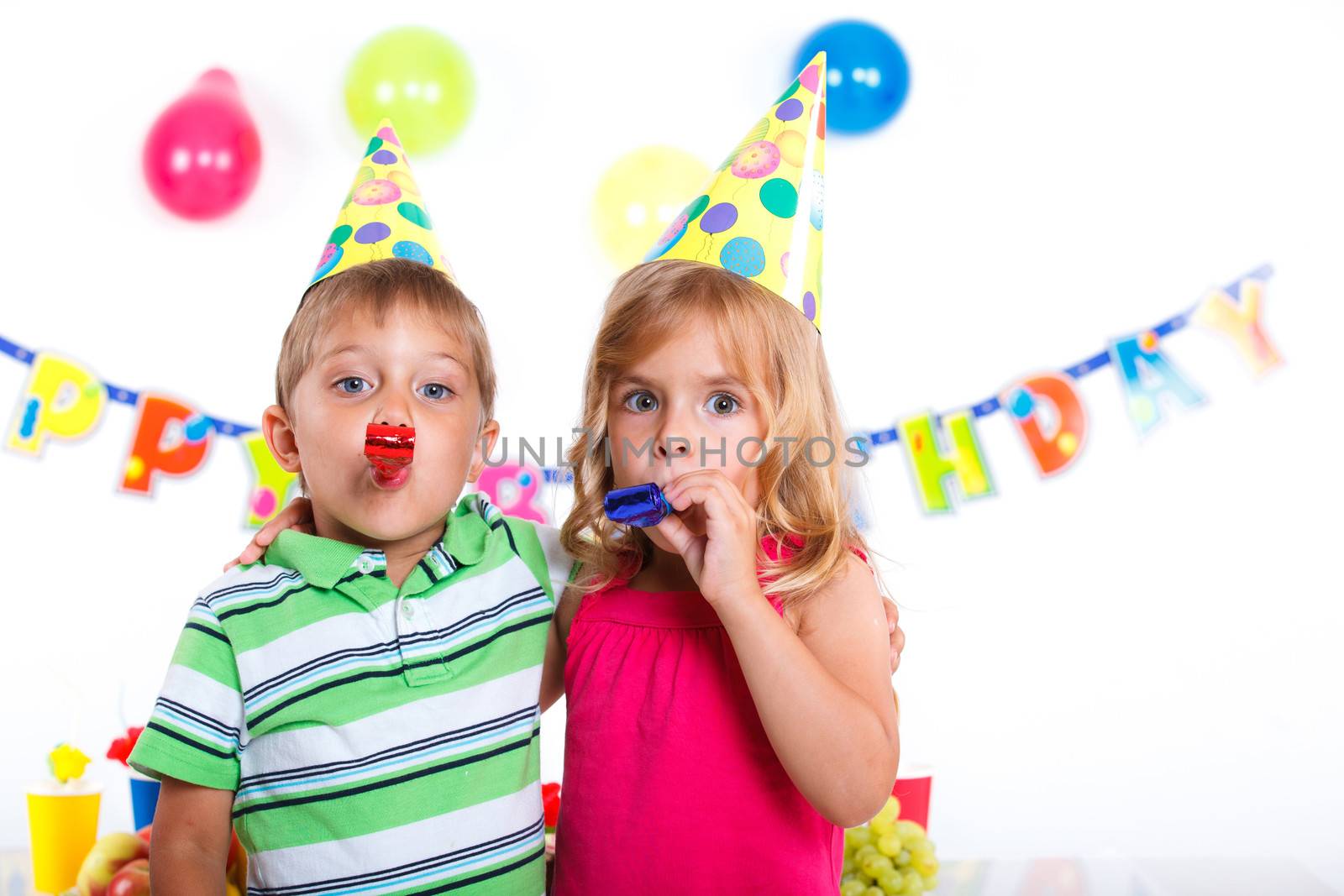 Cute girl and boy having fun at birthday party